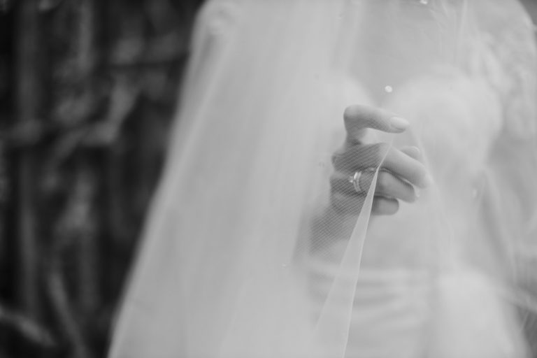 Bride touching veil with hand close up